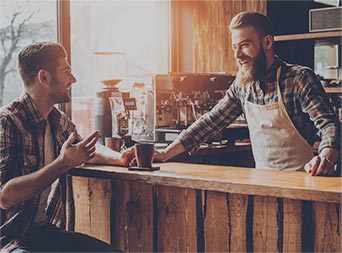 small business coffee shop owner smiling